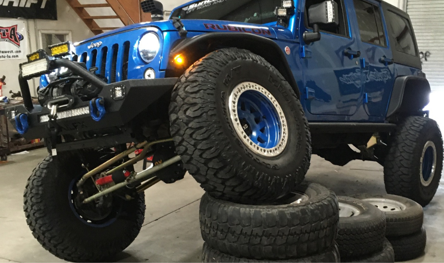 Offroad built Jeep with 36 inches of travel showing flex